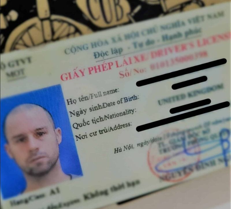 Vietnam motorbike licence card next to foreign passport